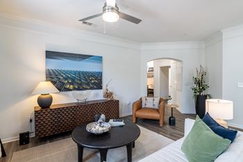 Living room with brown chair at Grand Villas at Cinco Ranch, Katy, TX, 77494